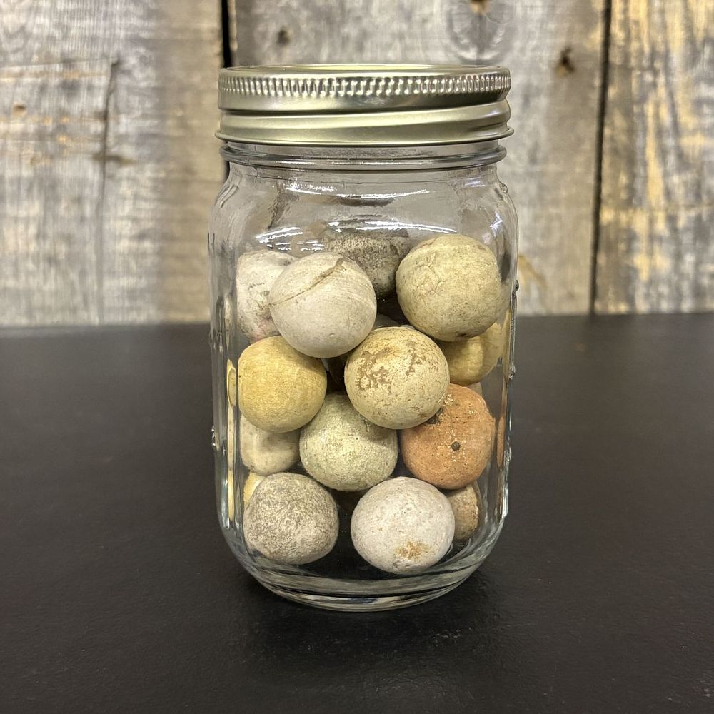 Lot 431: A Collection of Antique Hand-Formed Earthenware Marbles in a Glass Mason Jar
