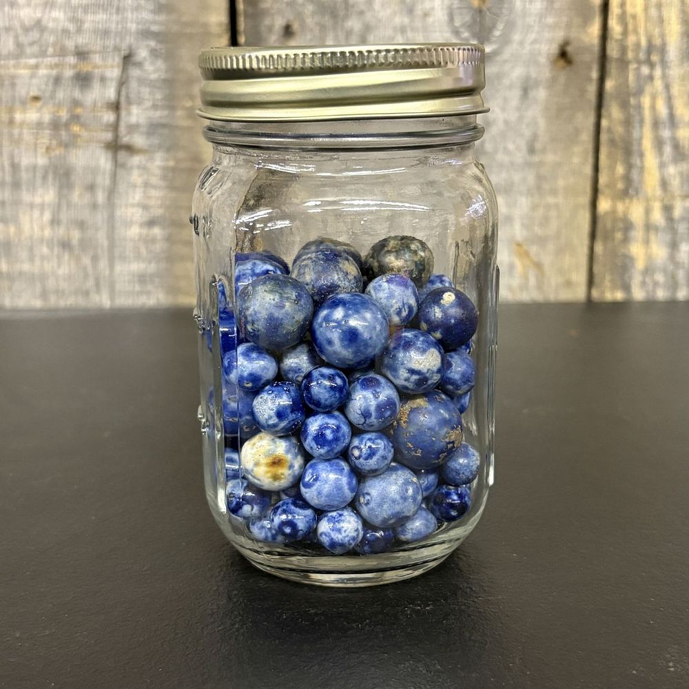 Lot 433: A Collection of Sodalite and Jasper Stone Marbles in a Glass Mason Jar