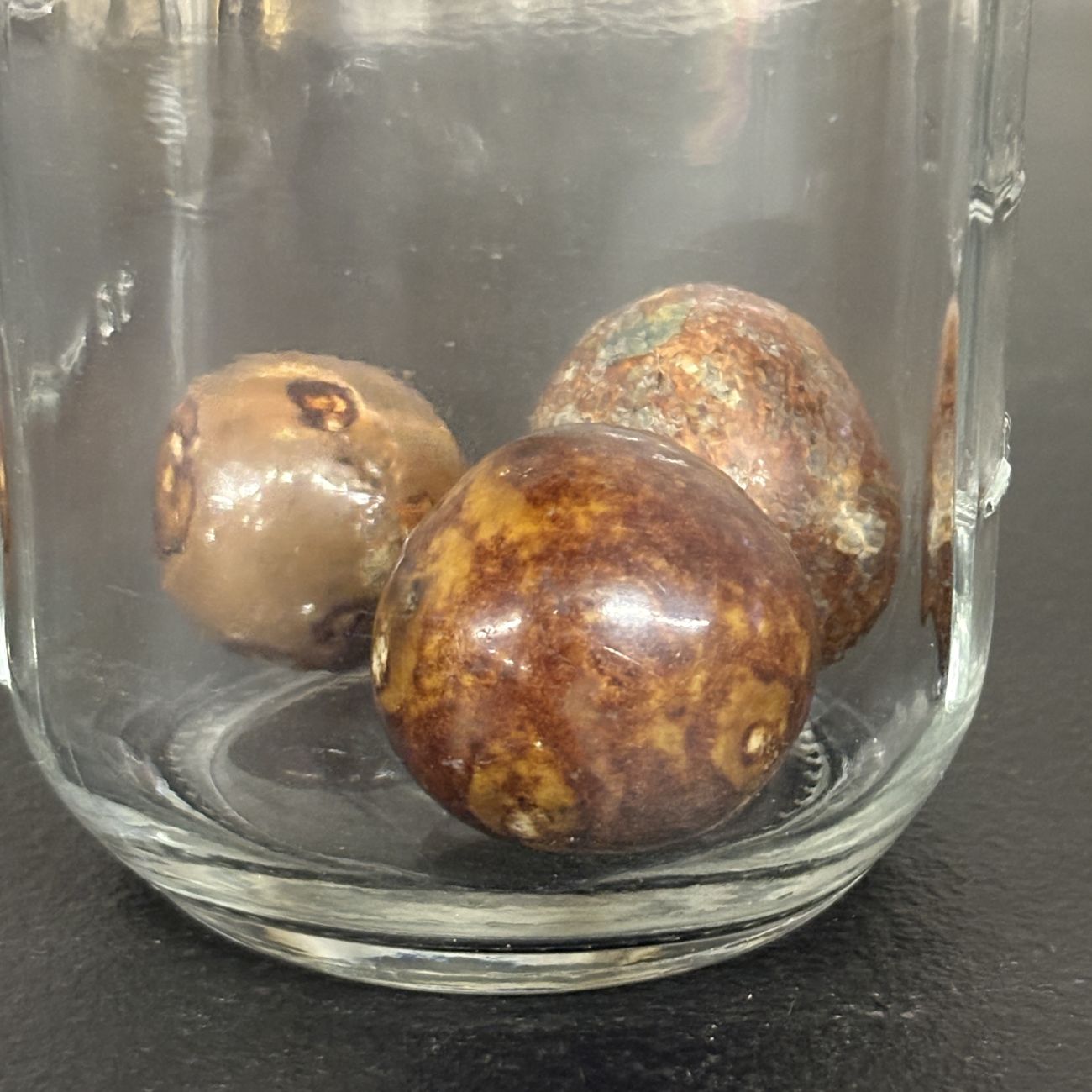 Three Antique Glazed Clay Marbles