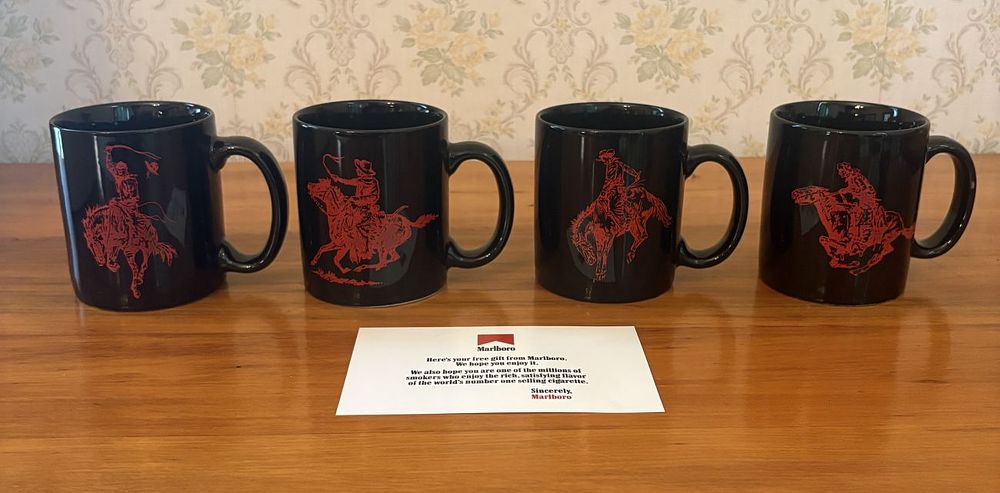 Lot 467: A Set of Four Marlboro Promotional Cowboy Motif Coffee Mugs and Original Packaging