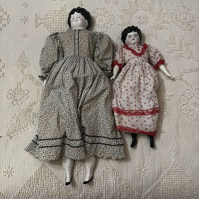 A Pair of China Head Dolls with Cloth Bodies and Molded Hair. A pair of antique-style china head 