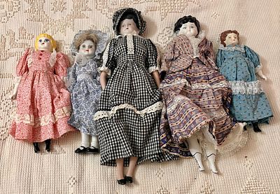 A Collection of Five Vintage Style Porcelain Dolls in Period Dress. A group of five dolls, each 