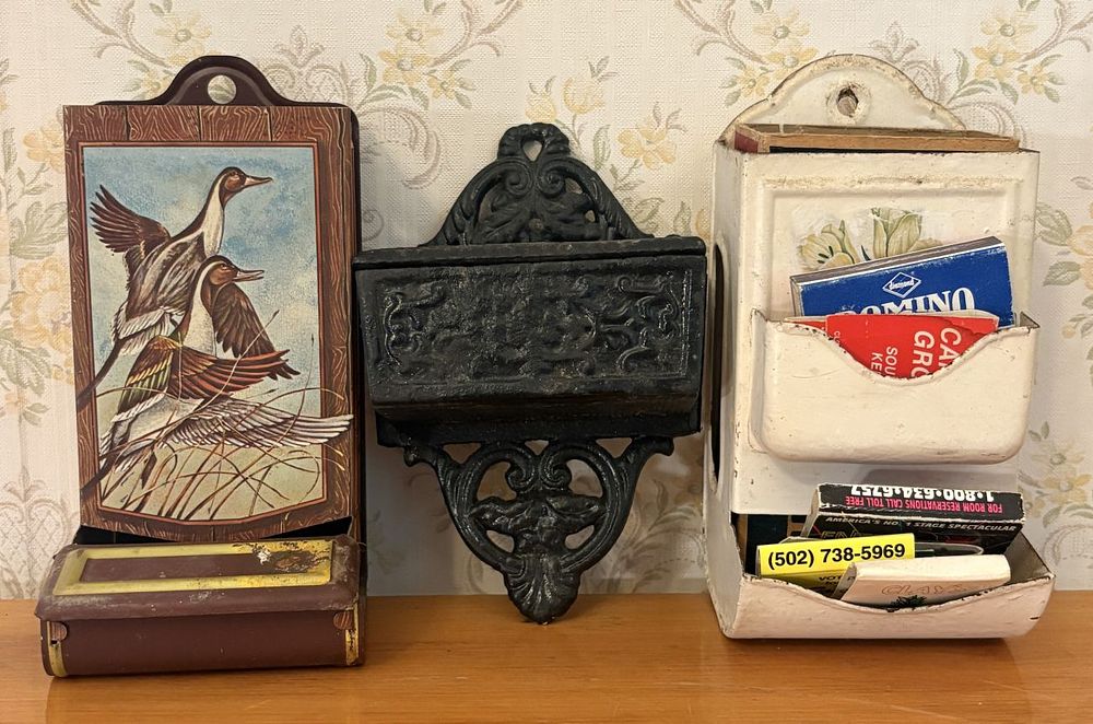 Lot 543: Trio of Vintage Wall Mounted Match Holders Including Lithographed Tin and Cast Iron
