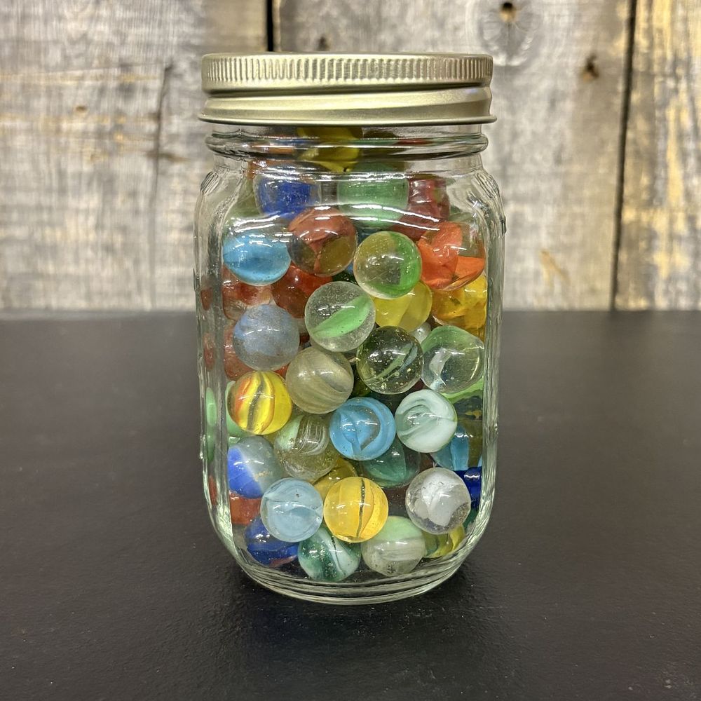 Lot 657: An Assortment of Vintage and Modern Glass Marbles in a Glass Jar