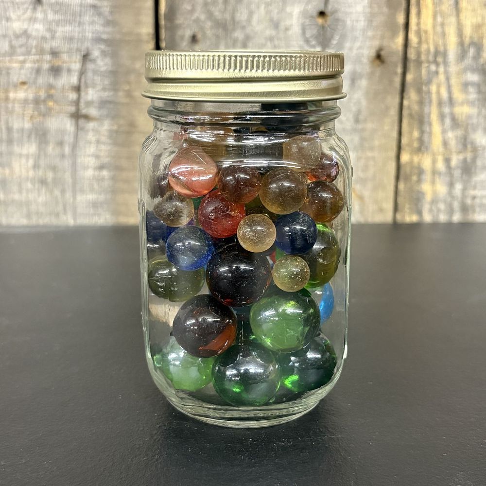 Lot 658: A Collection of Assorted Vintage Glass Marbles in a Graduated Mason Jar