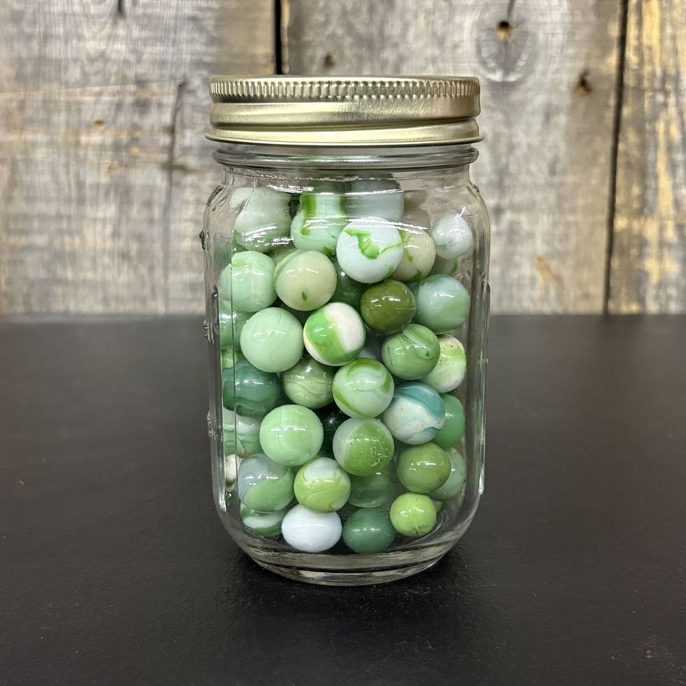 Lot 660: A Collection of Vintage Glass Marbles in a Graduated Mason Jar