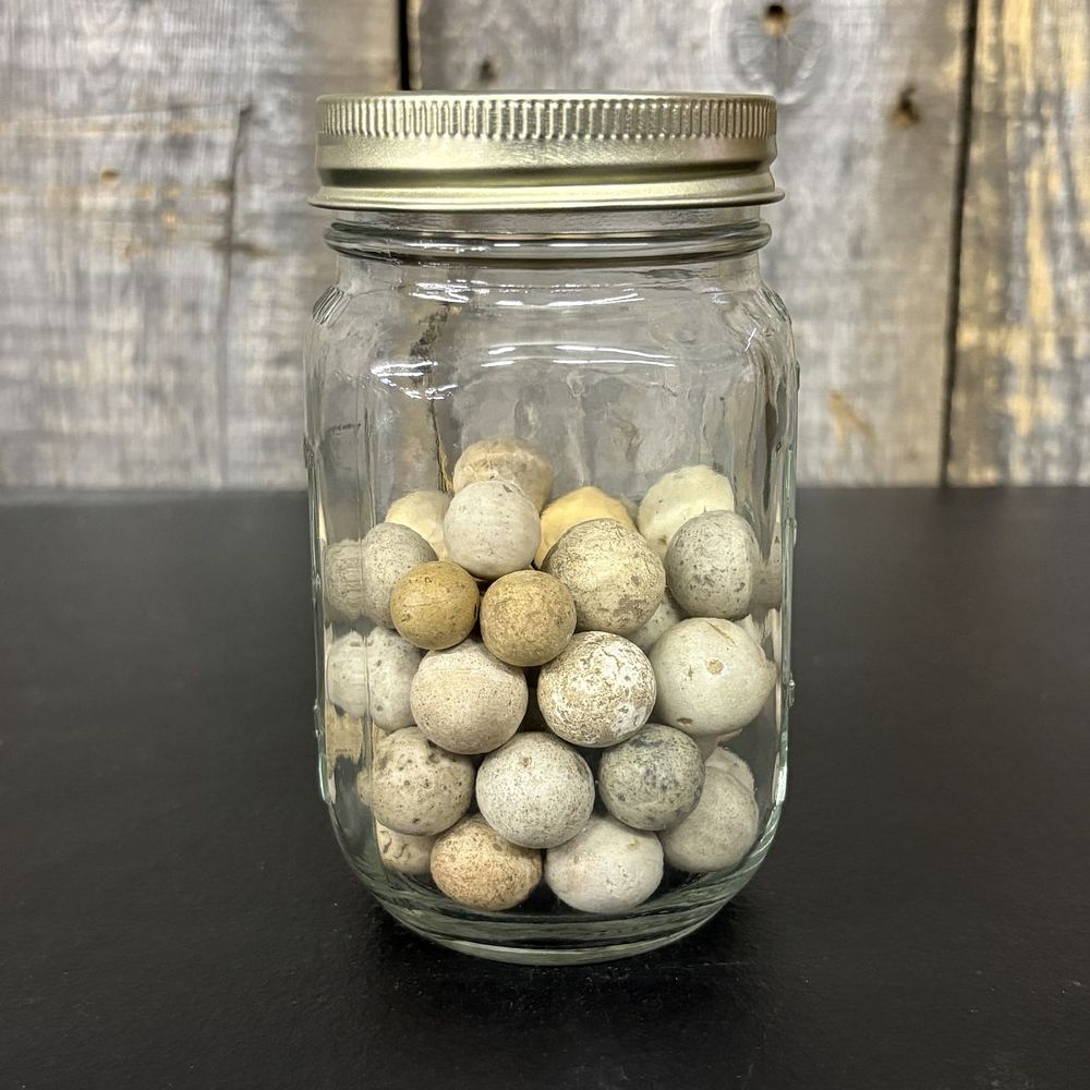 Lot 661: A Collection of Antique Clay Marbles in a Glass Jar