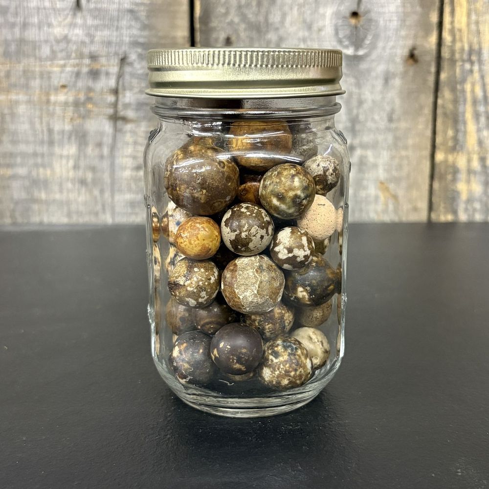 Lot 662: A Collection of Natural Stone and Clay Marbles in a Clear Glass Jar