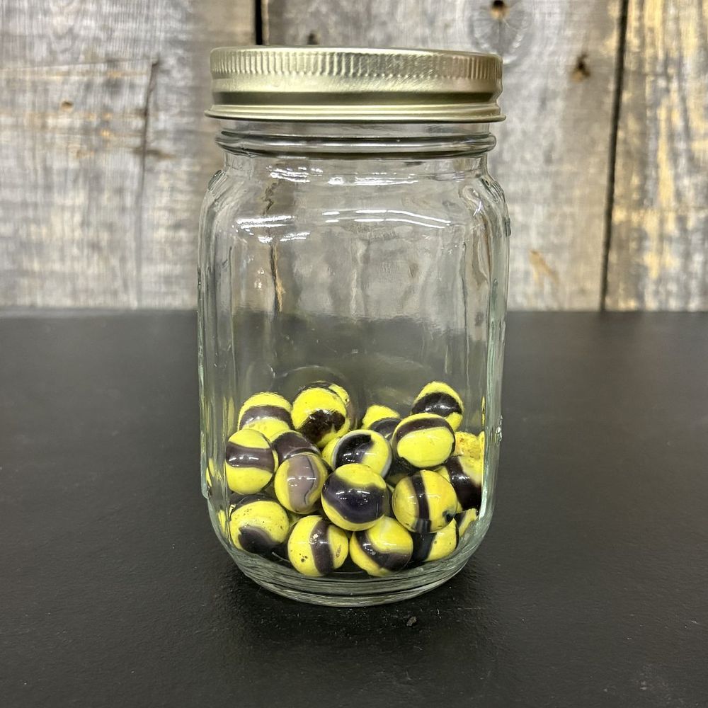 Lot 667: A Collection of Swirl Glass Marbles in a Mason Jar