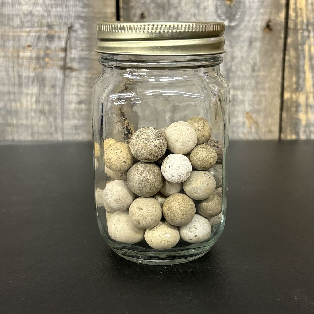 Lot 668: A Collection of Antique Hand-Rolled Clay Marbles in a Glass Jar