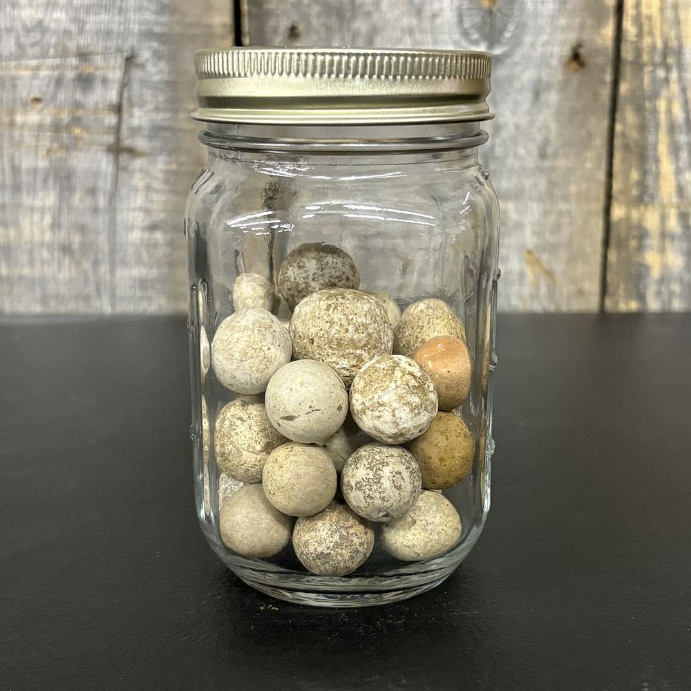 Lot 669: A Collection of Vintage Clay Marbles in a Glass Storage Jar