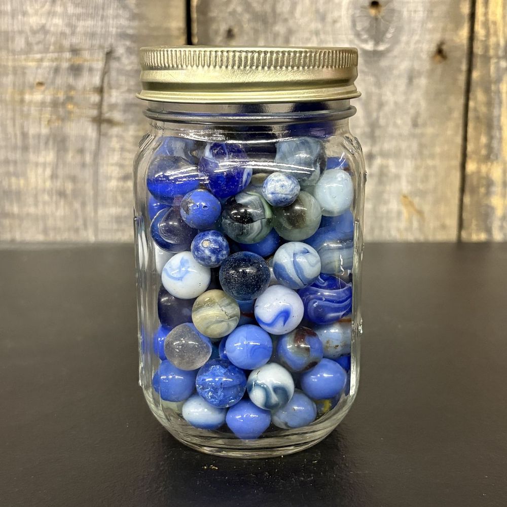 Lot 670: A Collection of Assorted Glass Marbles in a Glass Canning Jar