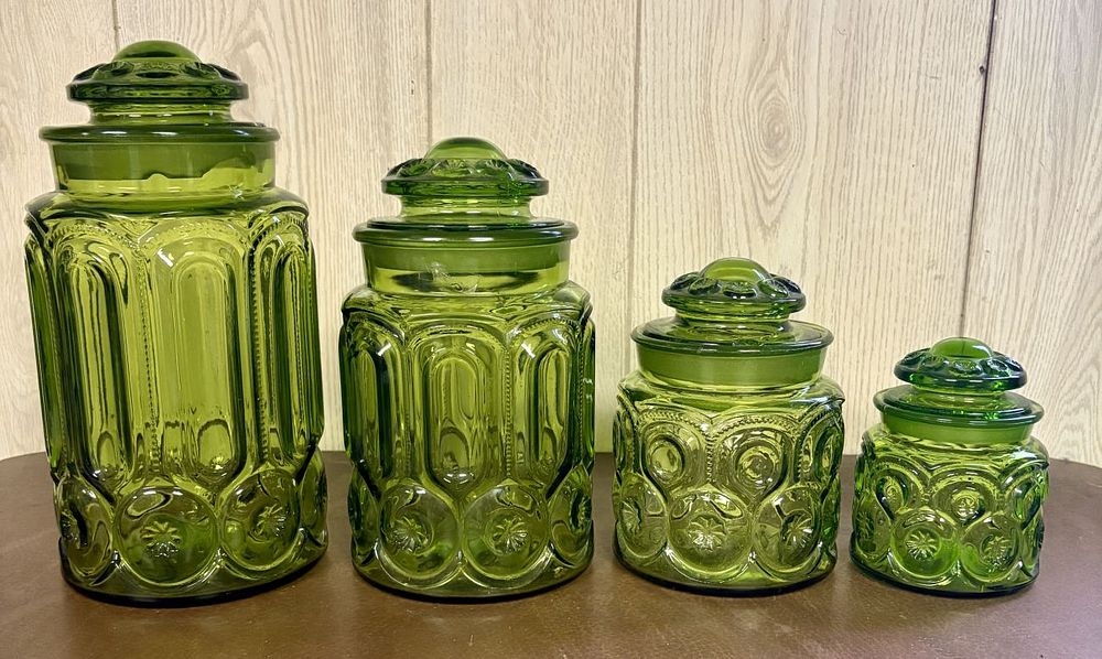 Lot 682: A Set of Four Graduated Pressed Glass Kitchen Canisters in Moon and Star Pattern