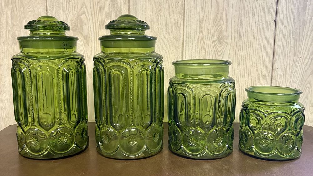Lot 683: A Set of Four Green Pressed Glass Moon and Star Pattern Canisters