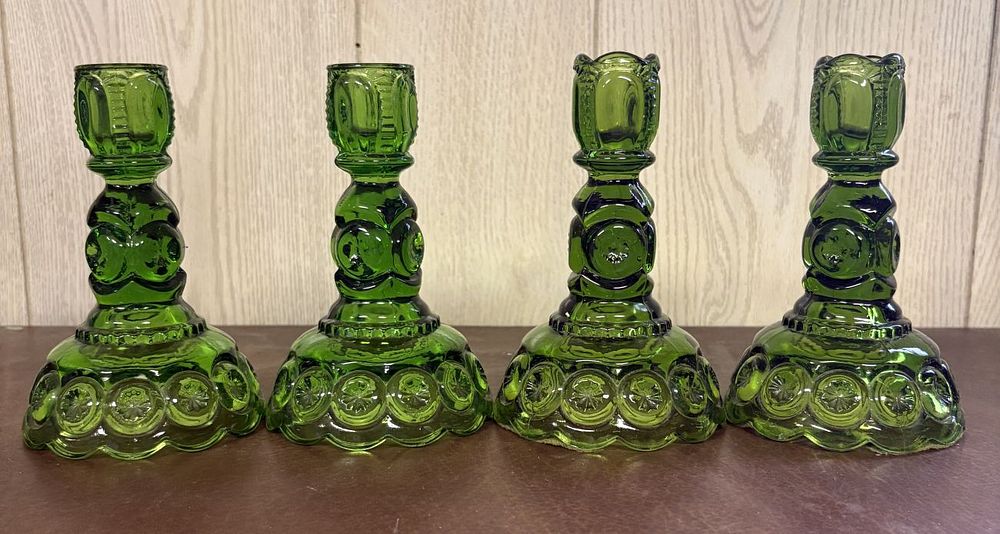 Lot 692: A Set of Four Green Moon and Star Pattern Pressed Glass Candlesticks