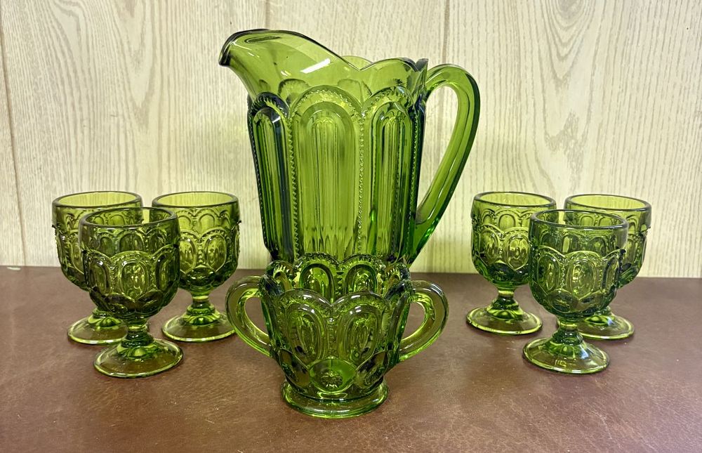Lot 693: A Set of Moon and Star Pattern Avocado Green Pressed Glass Beverage Ware and Service Pieces