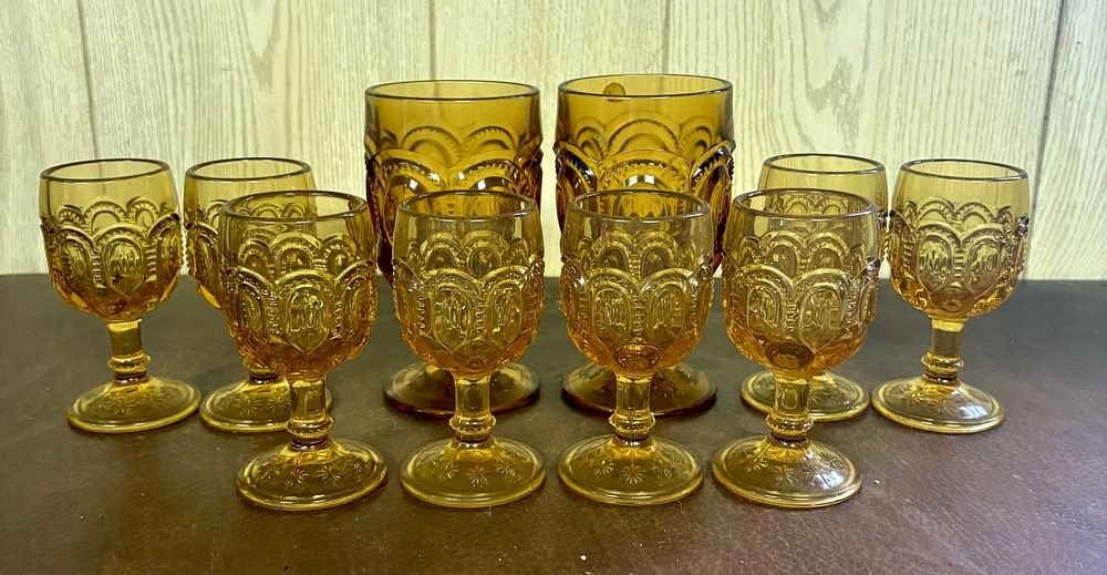 Lot 700: A Ten Piece Collection of Amber Pressed Glass Moon and Star Pattern Tableware