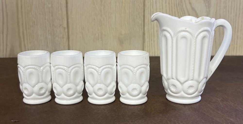 Lot 703: A Set of Moon and Star Pattern Milk Glass Miniature Pitcher and Tumblers