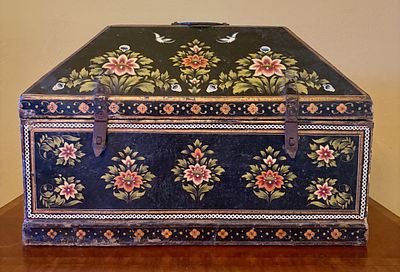 Early Floral Hand Painted Wooden Trunk. A hand-painted wooden trunk featuring a clipped-lid or 