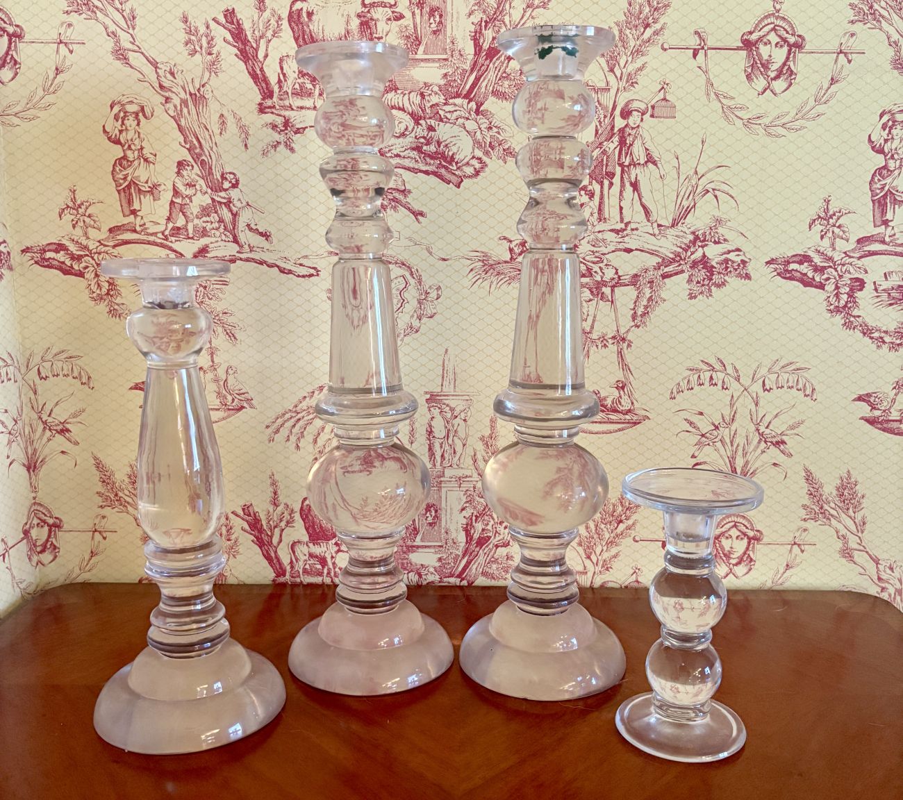 A Set of Four Graduated Clear Glass Candlesticks