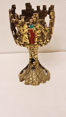 מעמד ישראליאנה לגביע קידוש, עשוי פליז, עם תבליט המרגלים נושאים אשכול ענבים. מעמד ישראליאנה 