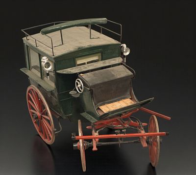 Closed passenger carriage. A closed, four-wheeled carriage with a wooden body painted green and 