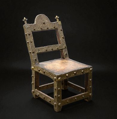 Asipim chair, Ashanti people, Ghana, circa 1910–1920. Wood, metal, and leather. Dimensions: 82 &times; 