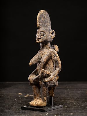Mother figure with two children, Yoruba people, Nigeria, 20th century. Carved wood. Dimensions: 