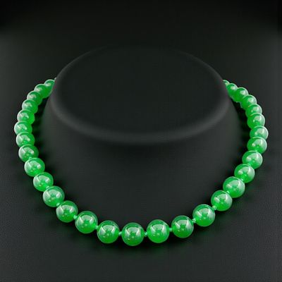 Green jade bead necklace, 20th century. Jade, spherical carving technique, and strung together 