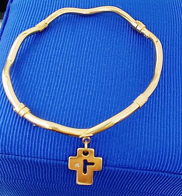 18-karat gold slave bracelet with cross and diamond pendant. 18-karat yellow gold bracelet with 