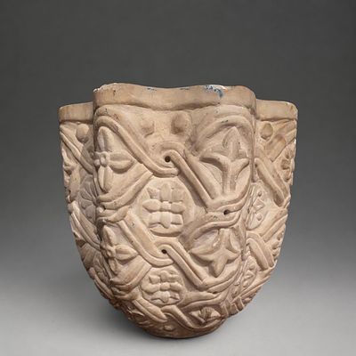 Romanesque holy water font with vegetal scroll decoration, France, 12th-13th century. Carved 