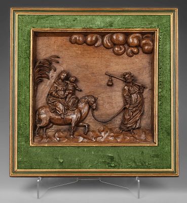 The Flight into Egypt, European School, 17th Century. Walnut panel with relief carving, in a 