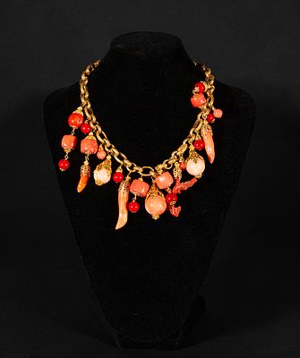 Gold-plated silver necklace with coral. It features a large link chain from which multiple 