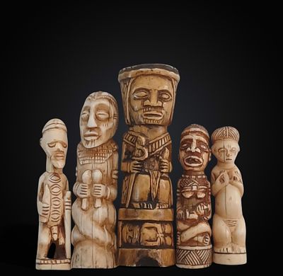 Group of five figures carved from warthog bone, representing tribal characters, Nigerian 