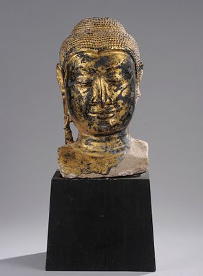 Buddha head, Ayutthaya Kingdom, 17th century. Lacquered and gilded sandstone. Measures 57 cm in 