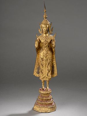 Buddha standing in abhayamudra richly dressed with uttarasanga and high tiara. Standing on a 