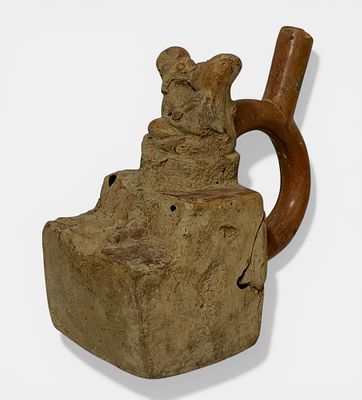 Erotic stirrup handle vase in beige terracotta with orange patina. Characteristic of the 