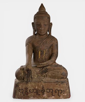 Buddha Maravijaya dressed in the monastic robe uttarasanga. Grey sandstone with traces of 