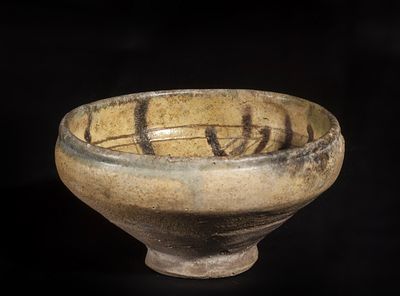 Deep ceramic bowl with beige glaze and brown decoration. Nishapur, Iran. 10th century. Height 