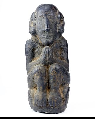 Animist ritual statue of Putali kneeling with hands joined in prayer. To protect springs 