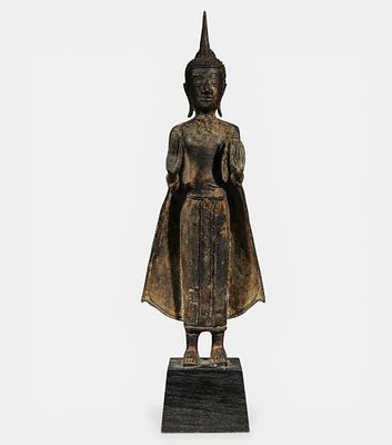 Buddha standing, unfurling the cloths of his monastic robe, Uttarasangha. In a gesture of 