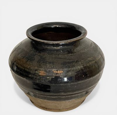 Globular stoneware flask with a wide, low belly and a short, open-rimmed neck. China. Yuan 