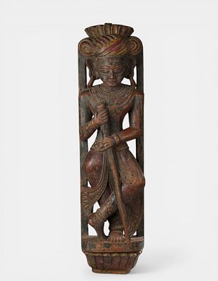 Temple architectural support beam carved with a figure wearing a turban and holding a staff. Wood 