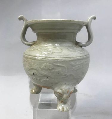 Pot-bellied tripod perfume burner with a large mouth and two side handles on the neck. Molded 