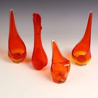 Four Mid Century orange art glass vases and candle holders, tallest is 10 inches tall
