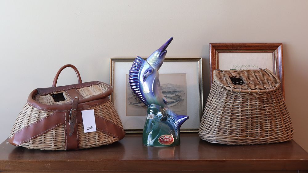 Lot 387: Two vintage bait baskets, a vintage bottle, and two art