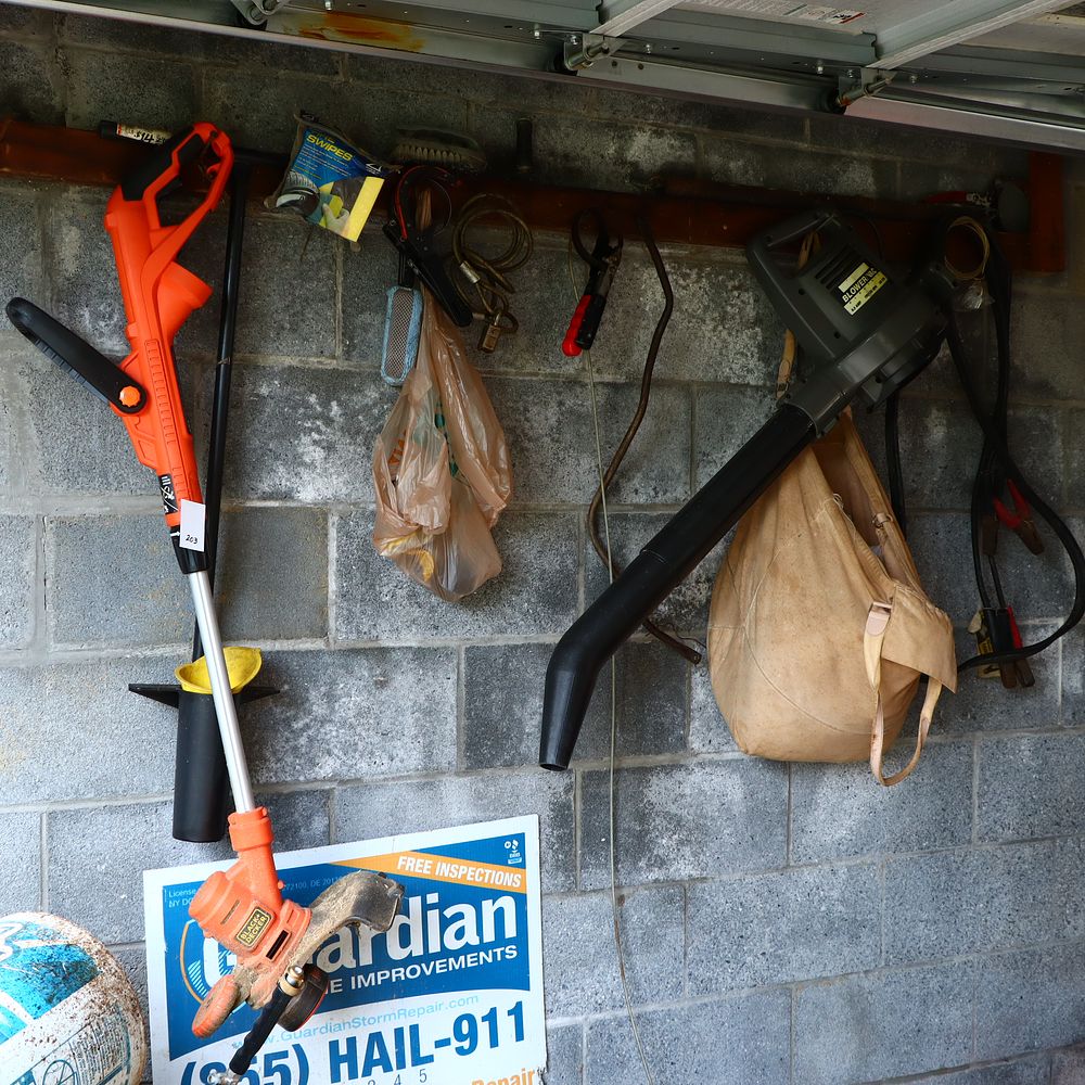 Lot 203: Black and Decker string trimmer and blower vac