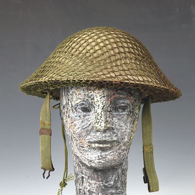 Antique military metal helmet with netting 12X11.5 inches