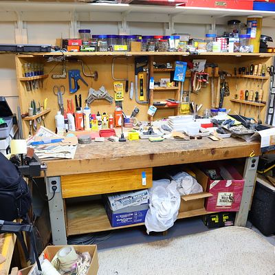Heavy Duty Wood and Metal Workbench. Wooden workbench with metal legs basement level but full