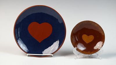 Two Contemporary Redware Heart Motif Plates by Joan Tatum and G. H. Feitig. This lot consists of 